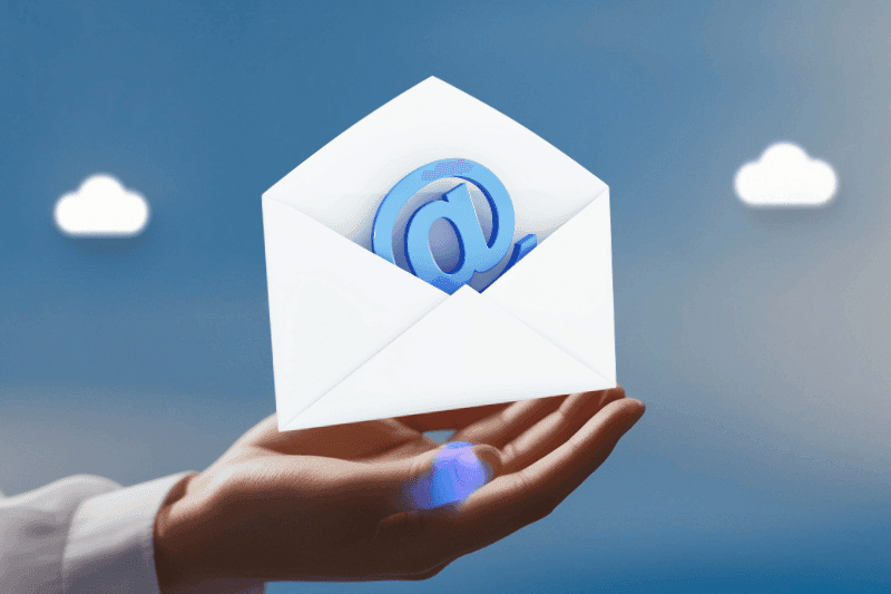 Open envelope with an @ symbol held on an open palm